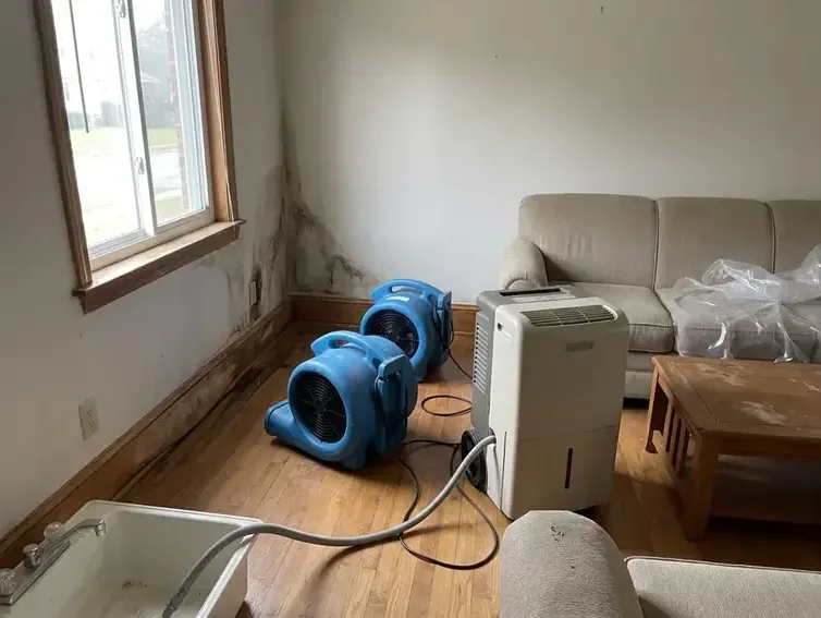 Drying equipment operating inside a water-damaged room